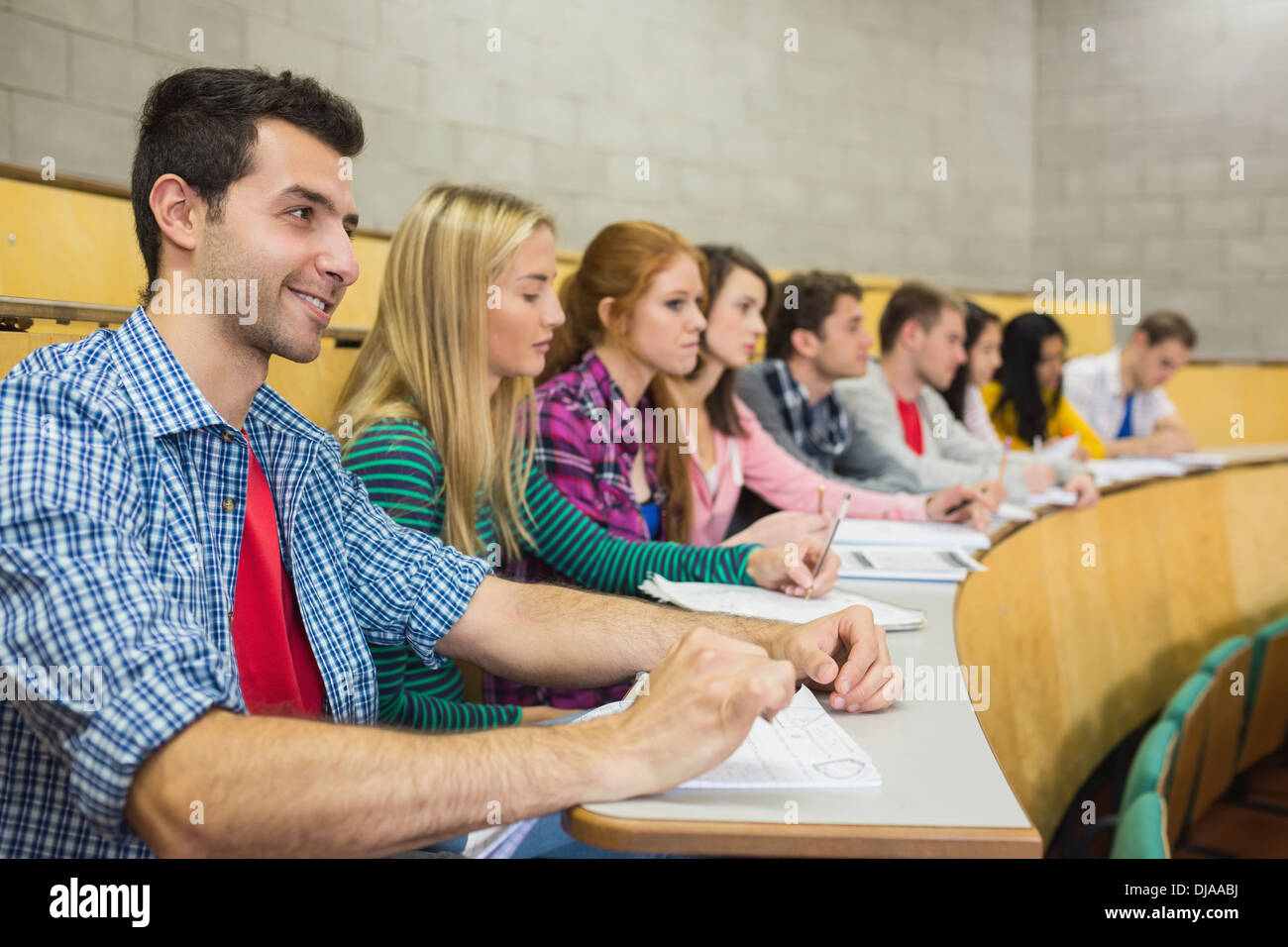 Students sitting in a row at the lecture hall Stock Photo