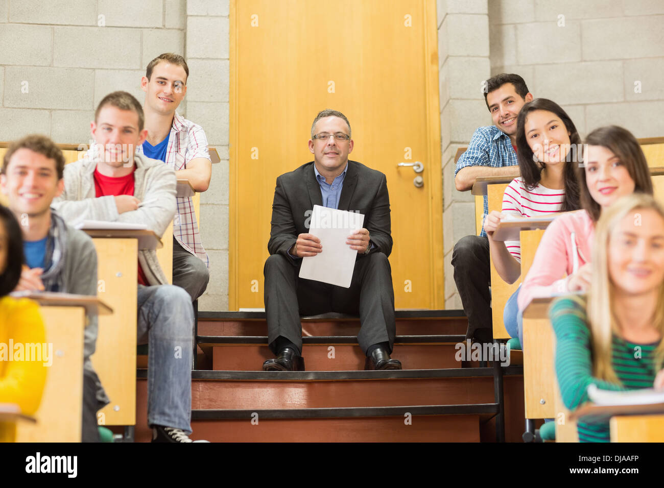 Elegant teacher with students sitting at the lecture hall Stock Photo