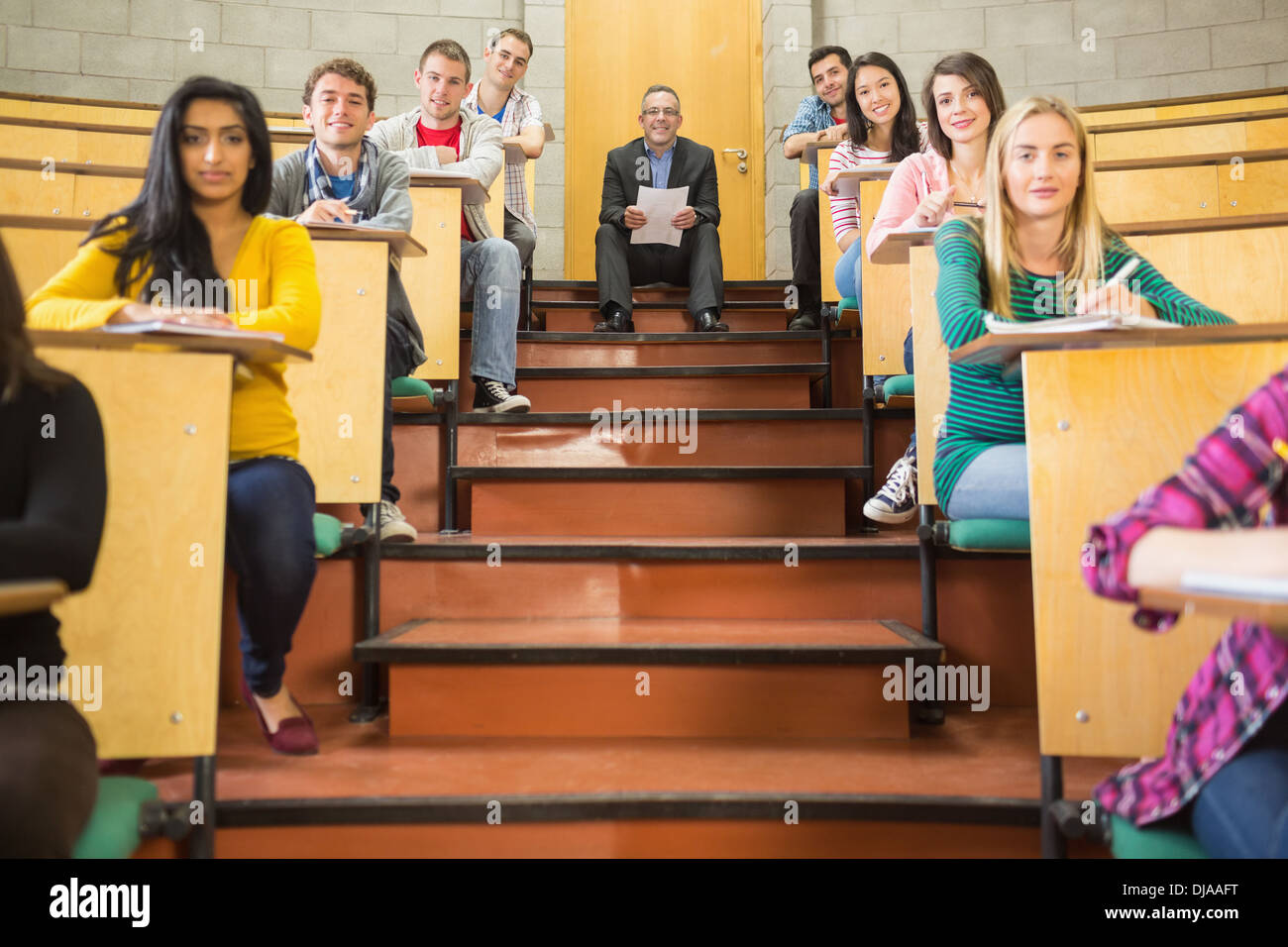 Rlegant teacher with students sitting at the lecture hall Stock Photo