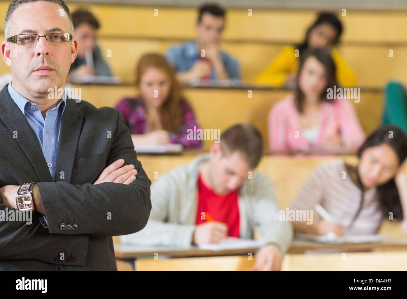 Portrait of an elegant teacher with students at lecture hall Stock Photo