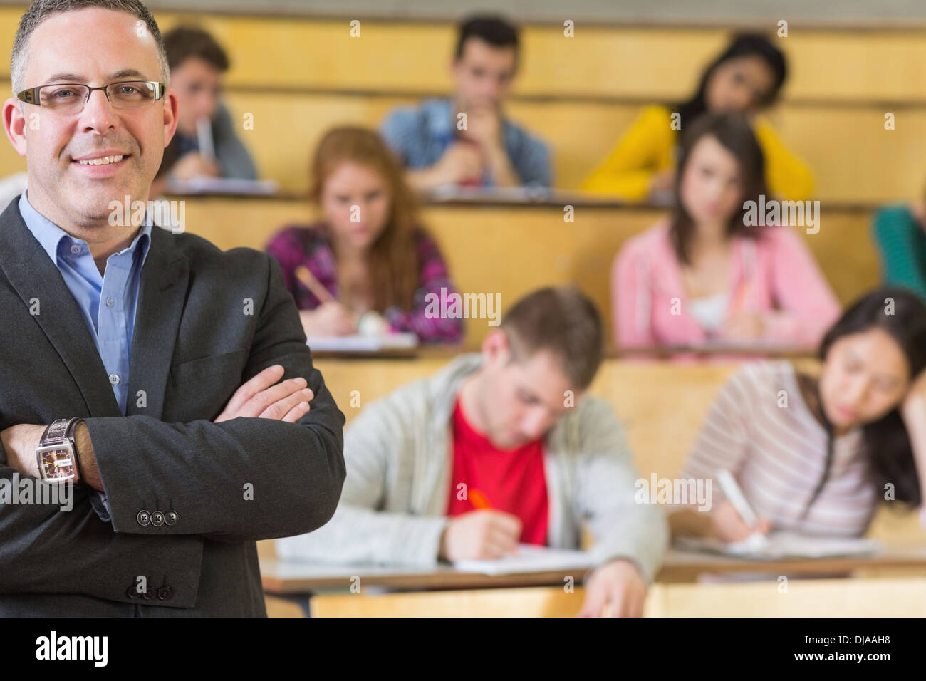 Elegant teacher with students sitting at lecture hall Stock Photo