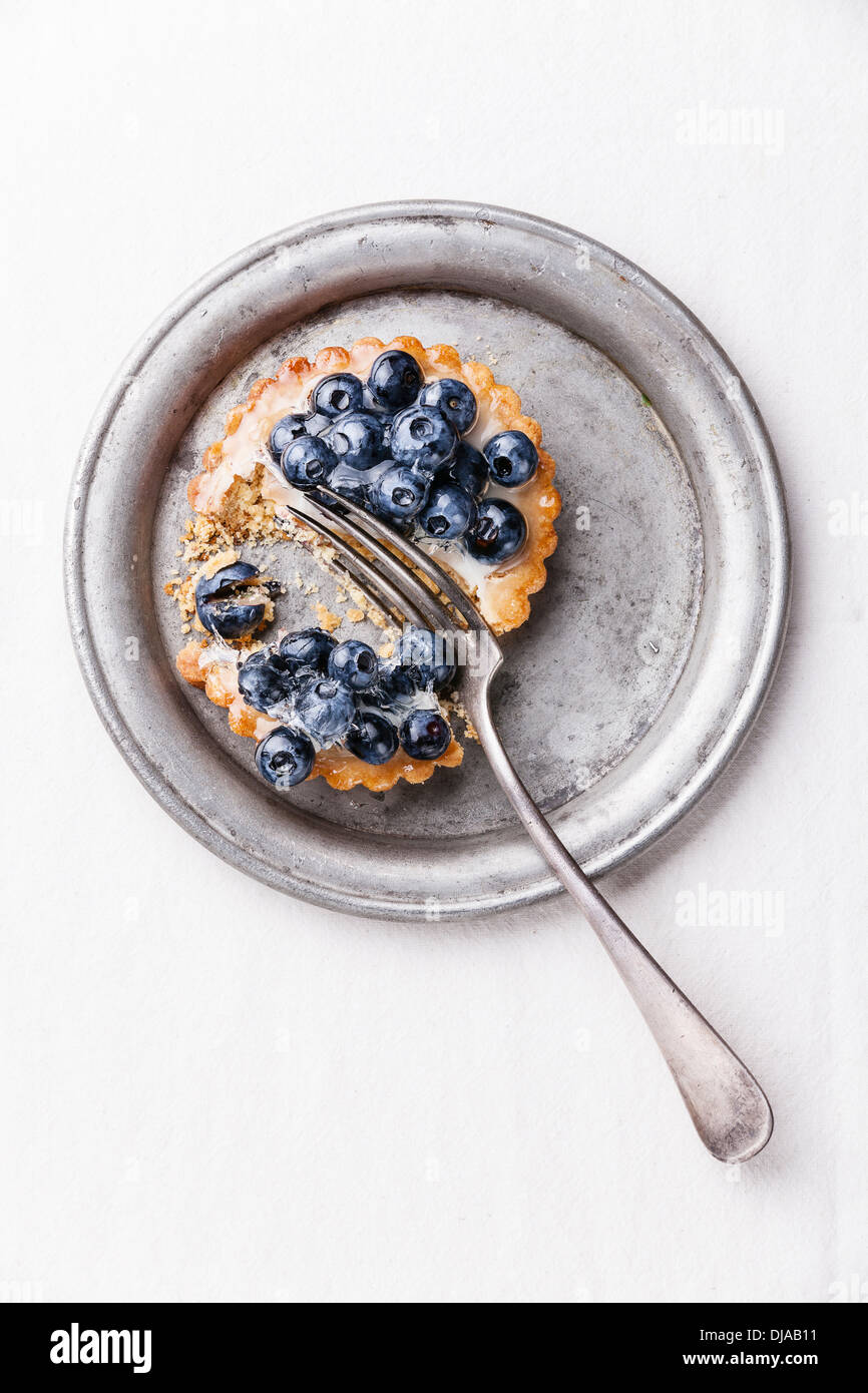 Cutting Blueberry tart on white background Stock Photo