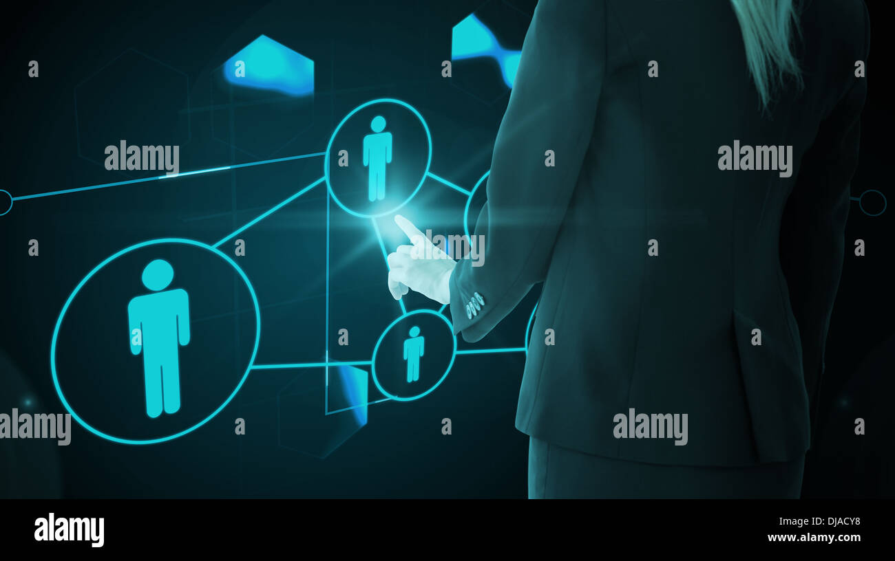 Composite image of businesswoman pointing on glowing futuristic blue background Stock Photo