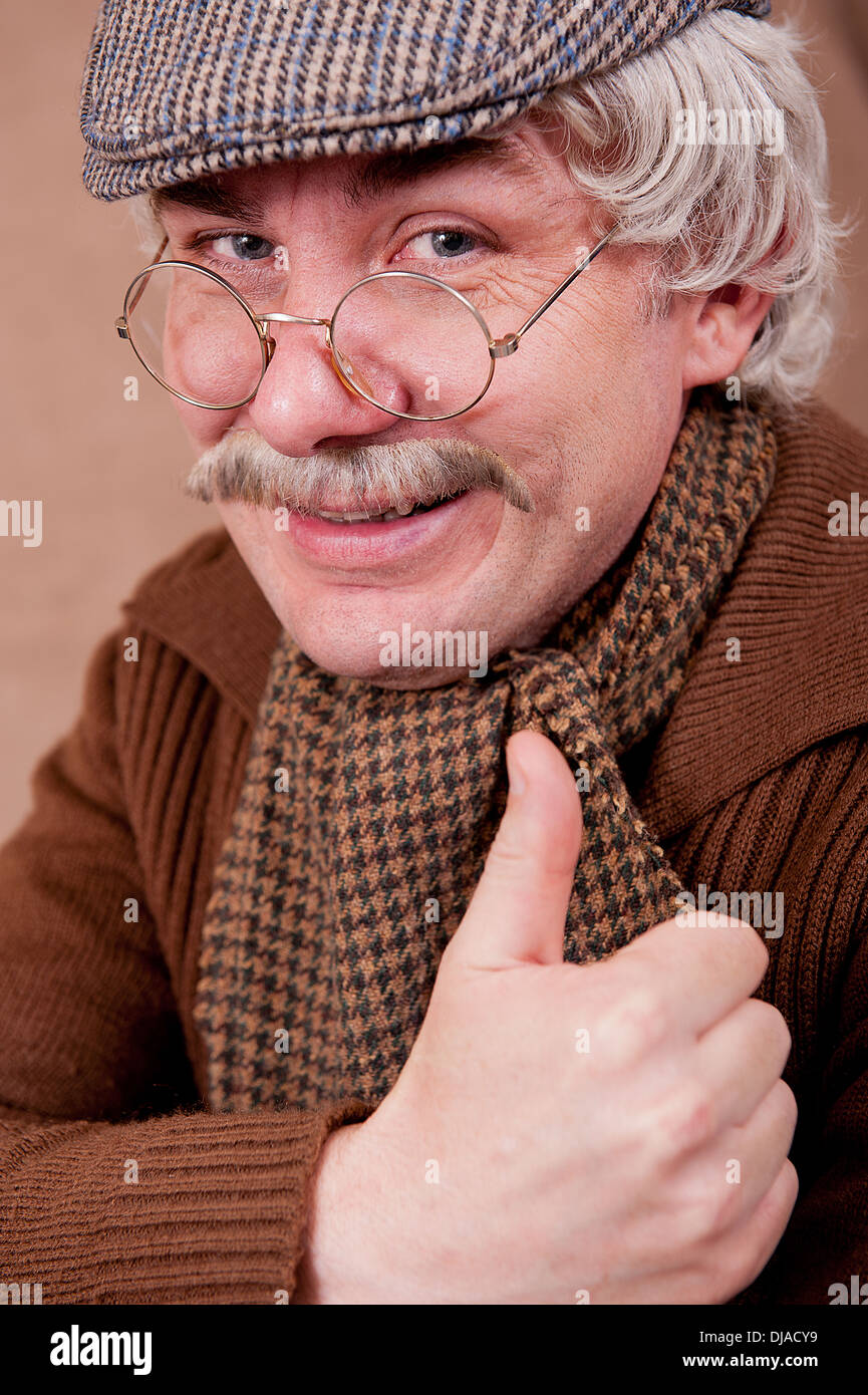 Grey haired old man with a big smile and a thumbs up towards camera. Stock Photo