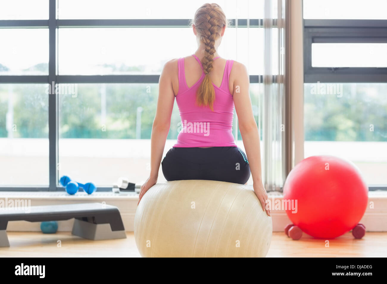 Fit beautiful woman sitting on exercise ball Stock Photo - Alamy