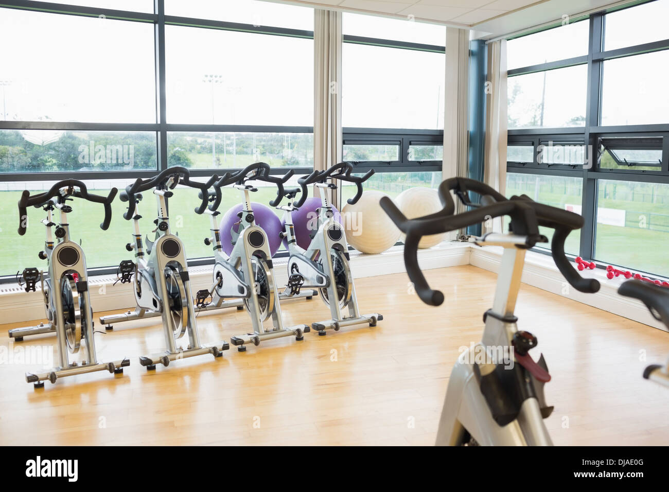 Spinning exercise bikes in gym room Stock Photo
