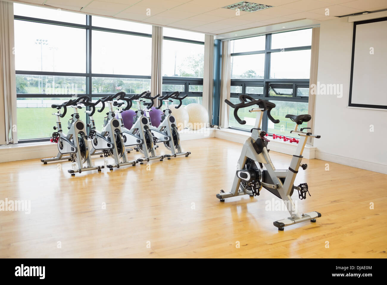 Spinning exercise bikes in gym room Stock Photo