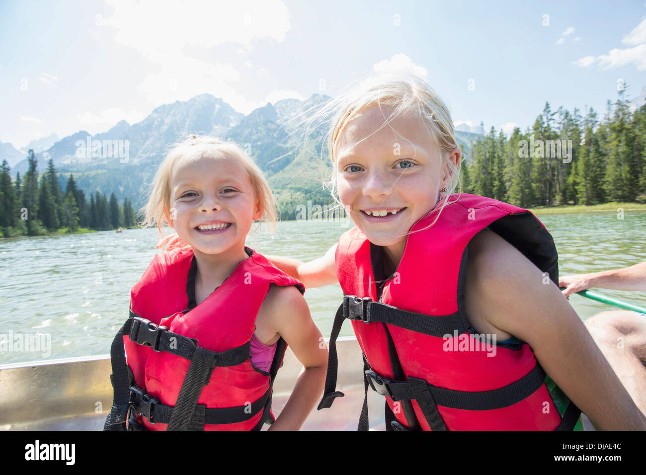 Caucasian girls wearing life jackets in canoe Stock Photo Alamy