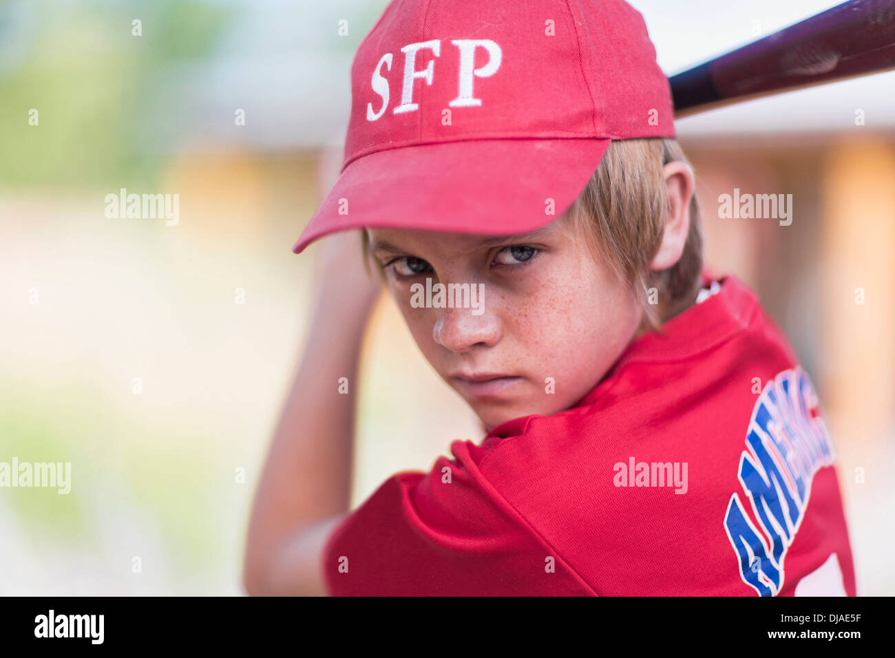 Caucasian boy playing baseball outdoors Stock Photo