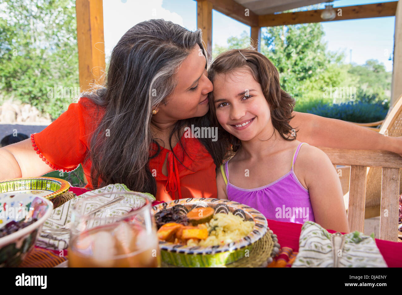 Mother and daughter eating at table Stock Photo
