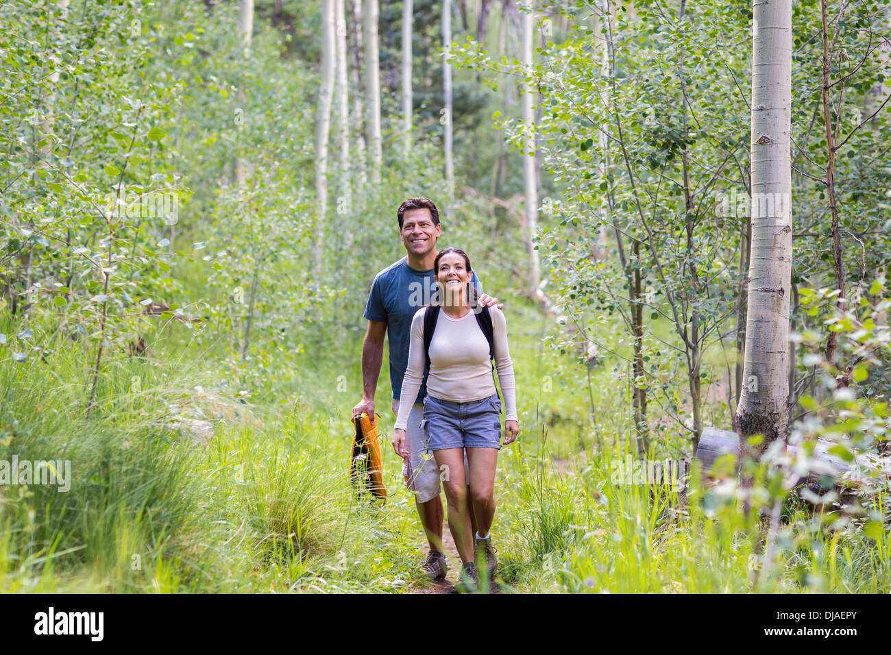 Couple walking together in forest Stock Photo