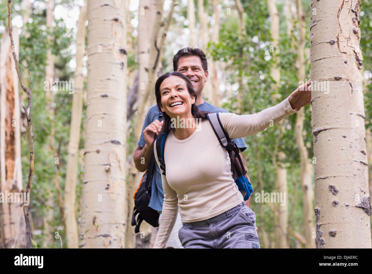 Couple walking together in forest Stock Photo