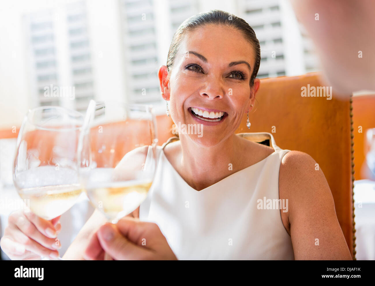 Couple toasting each other at restaurant Stock Photo