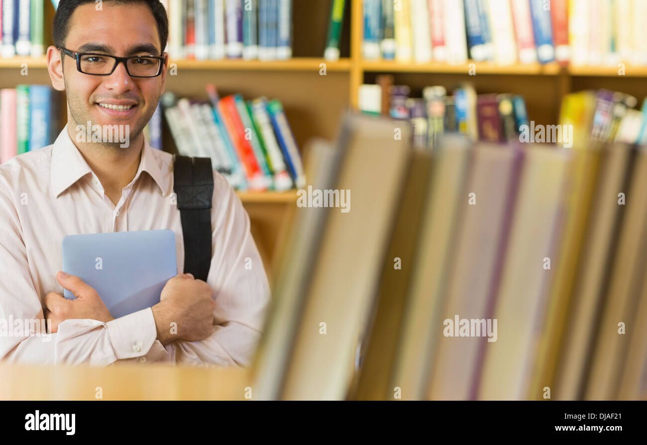 Smiling mature student with tablet PC in library Stock Photo