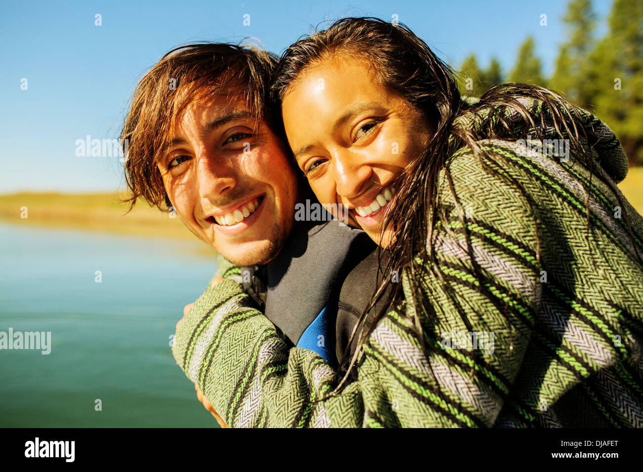 Couple hugging by rural lake Stock Photo