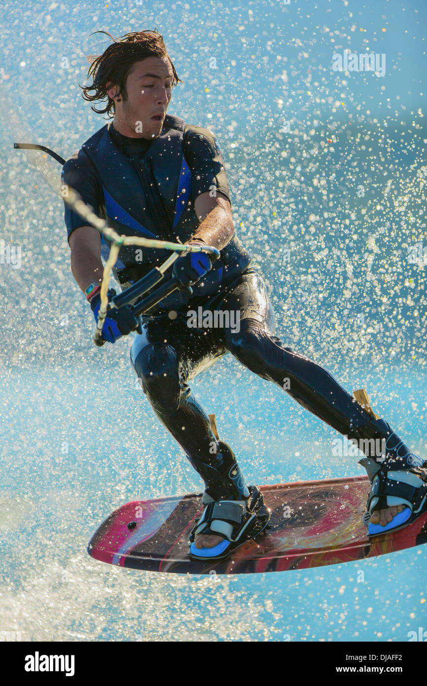 Caucasian man wakeboarding on lake Stock Photo