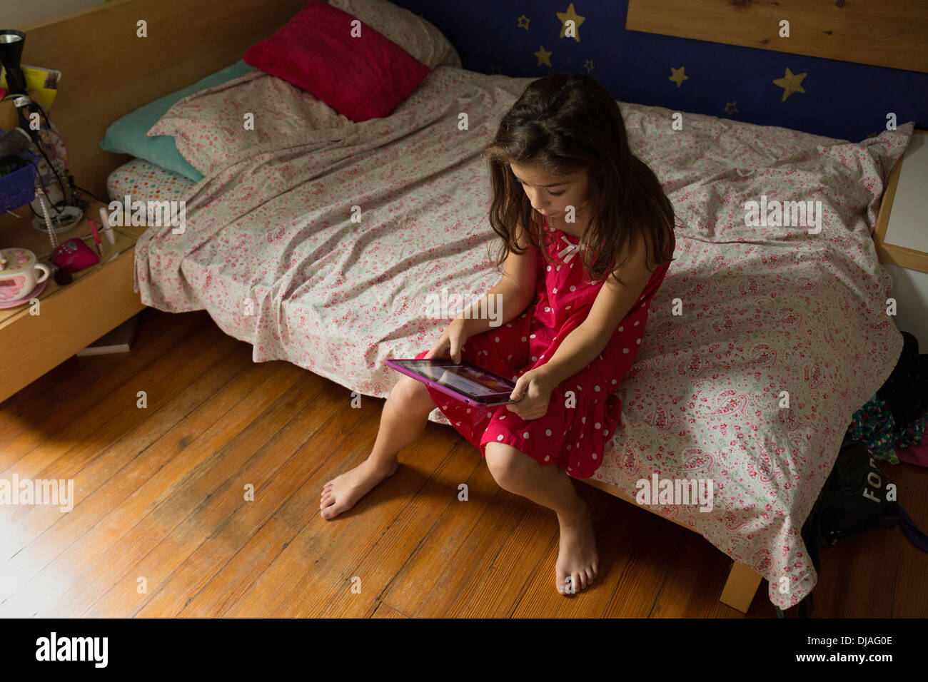 Mixed race girl using digital tablet Stock Photo