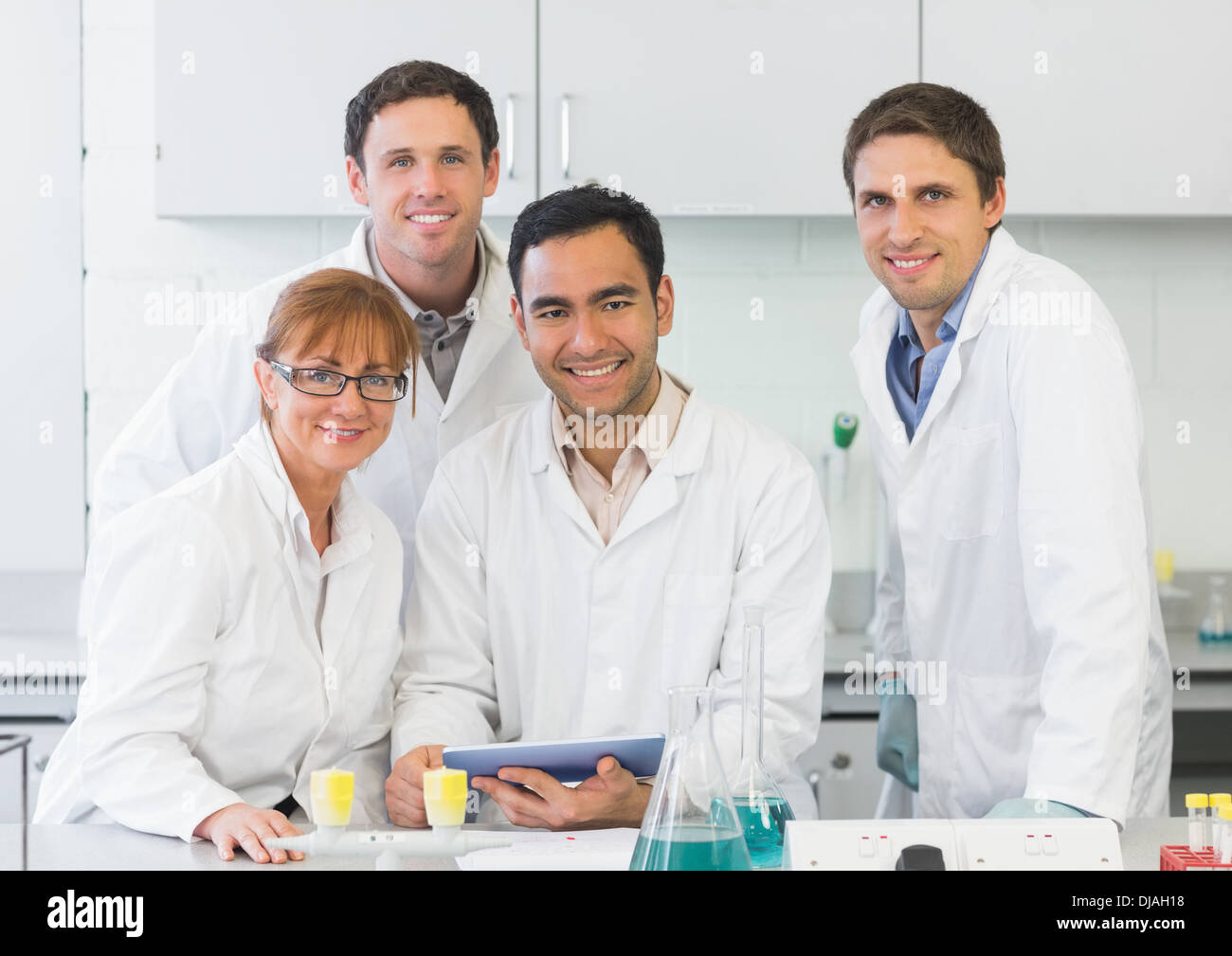 Smiling scientists with tablet PC in the lab Stock Photo