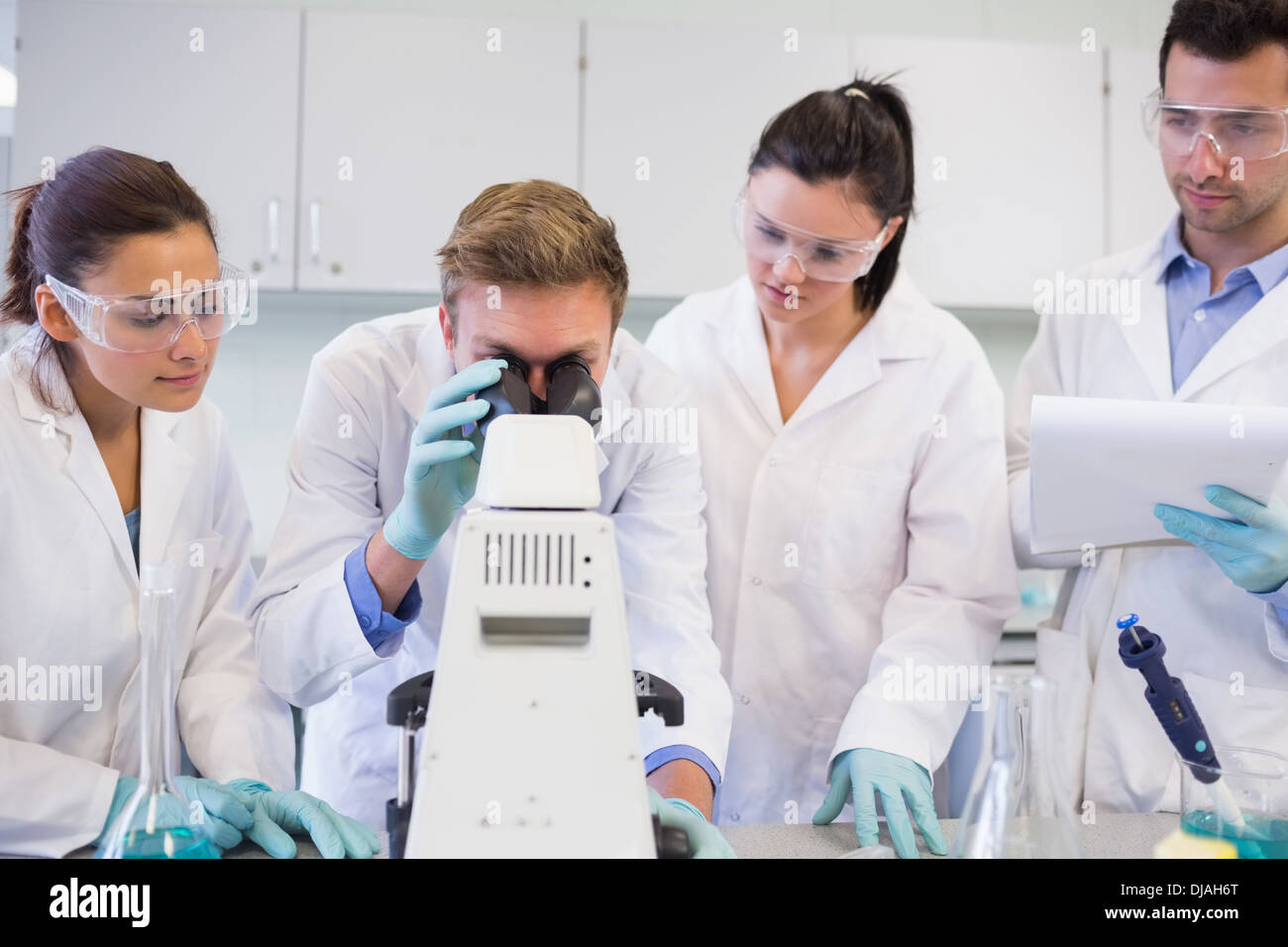 Scientists with microscope in the laboratory Stock Photo