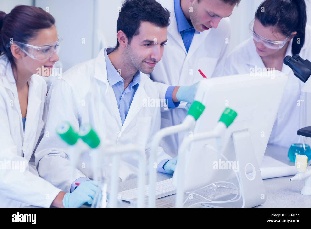 Researchers looking at computer screen in the lab Stock Photo