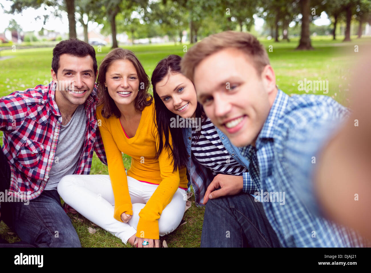 Cheerful young college students in park Stock Photo - Alamy