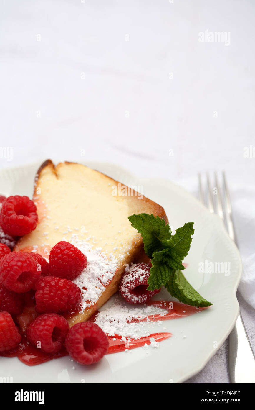 Close up of slice of cake with raspberries Stock Photo