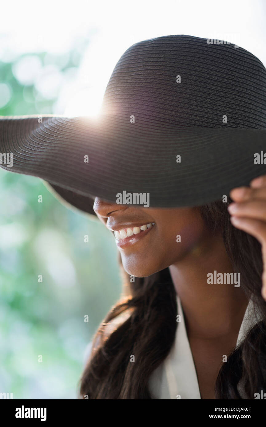 Black woman wearing sun hat Stock Photo