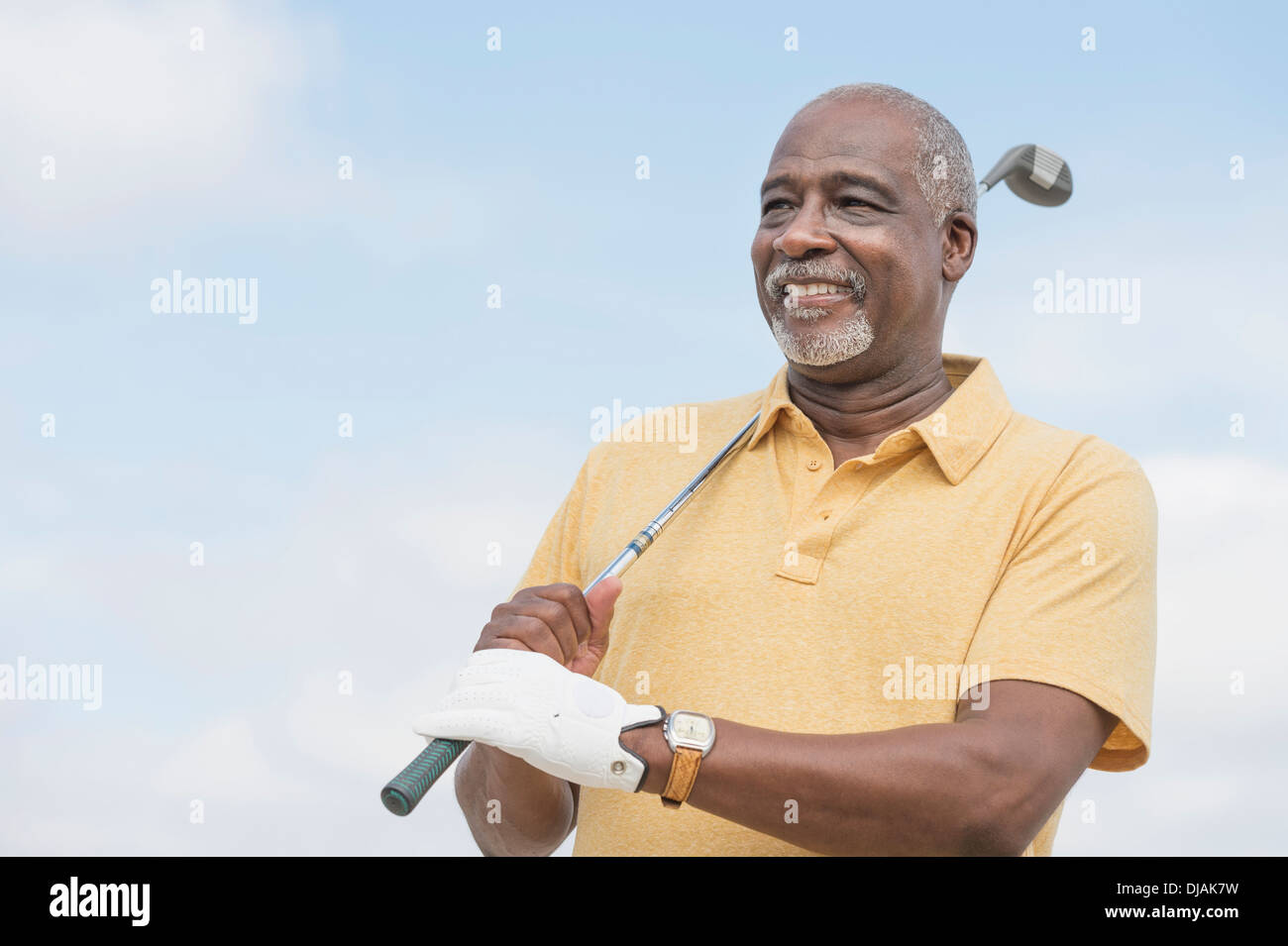 Black man playing golf outdoors Stock Photo