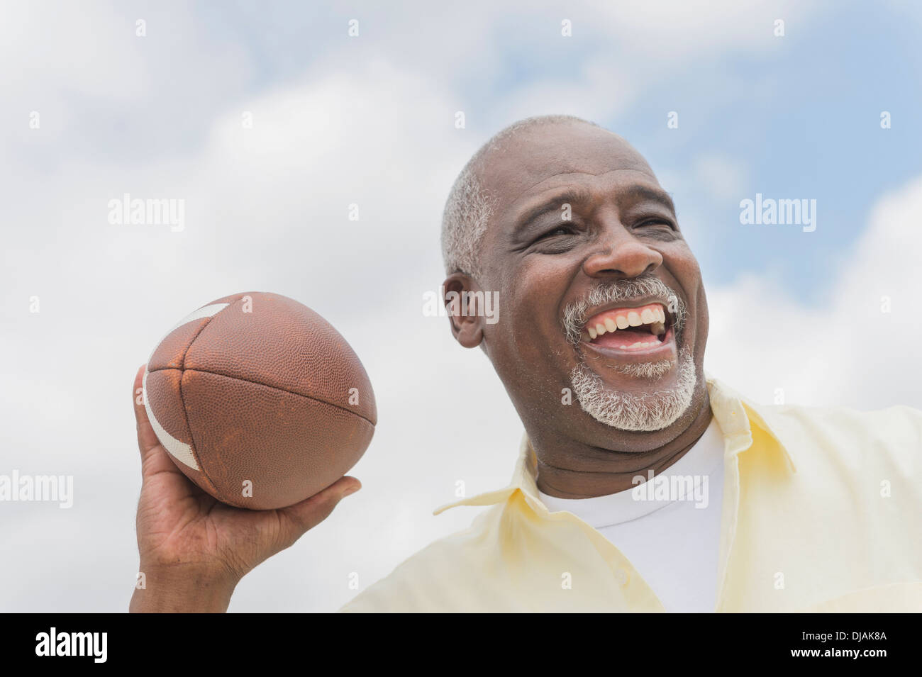 Black man throwing football outdoors Stock Photo Alamy