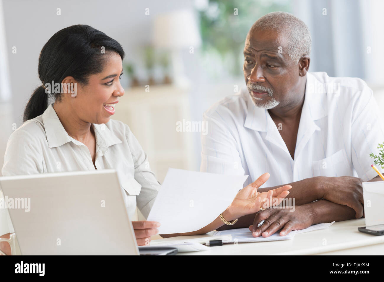 Black father and daughter using laptop Stock Photo