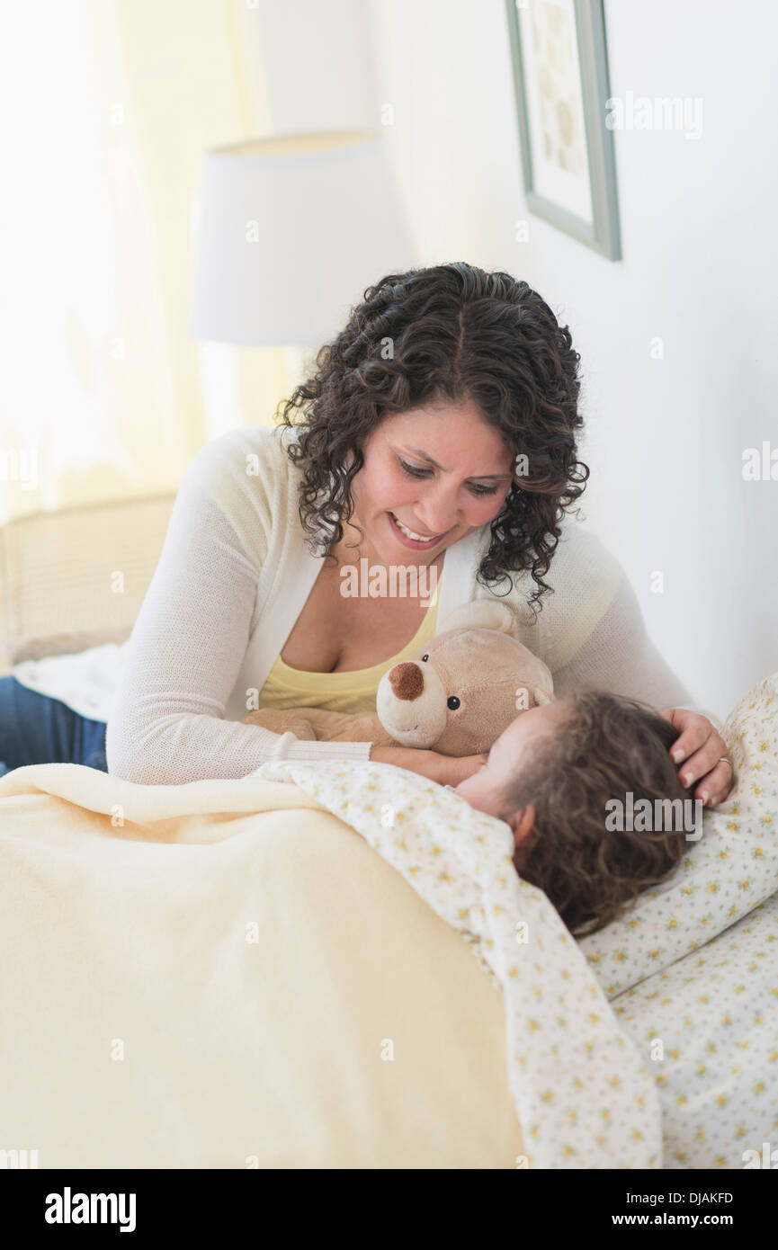 Mother tucking in daughter hires stock photography and images Alamy