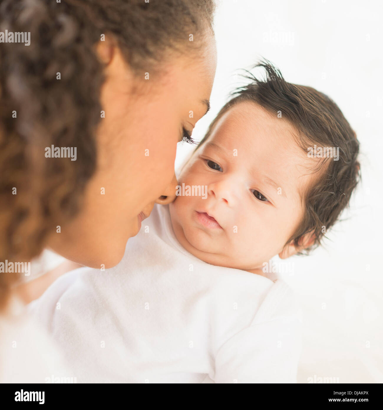 Hispanic mother nuzzling baby's cheek Stock Photo Alamy