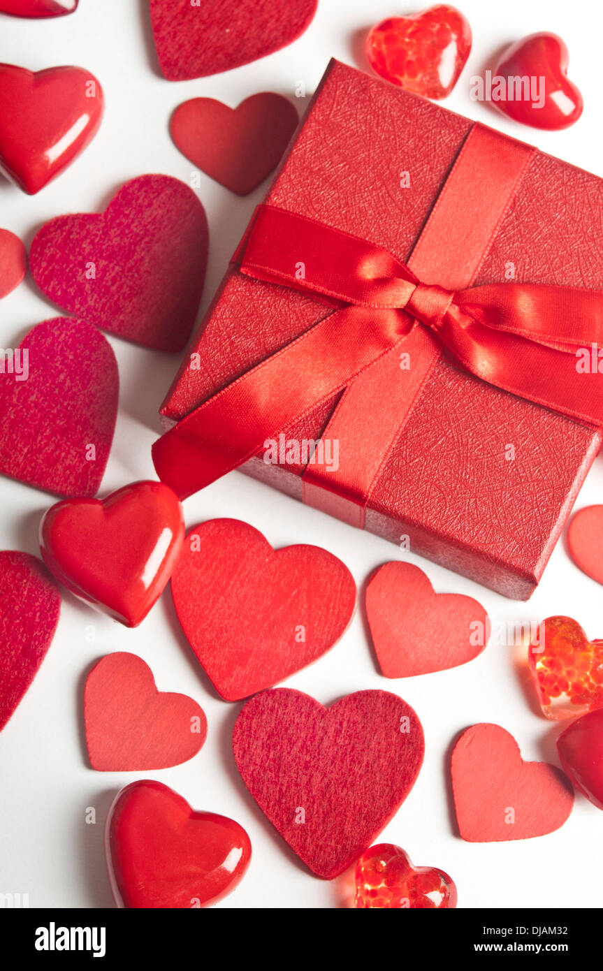 background of valentine red hearts with a gift box Stock Photo