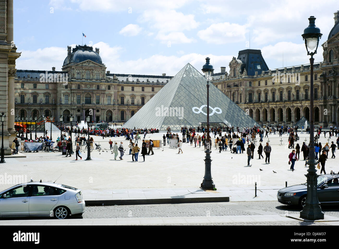 PARIS - May 22, . Tourists enjoy the Louvre on May 22, 2013 in Paris. The Louvre displays 35.000 artworks . Paris, May 22 2013 Stock Photo