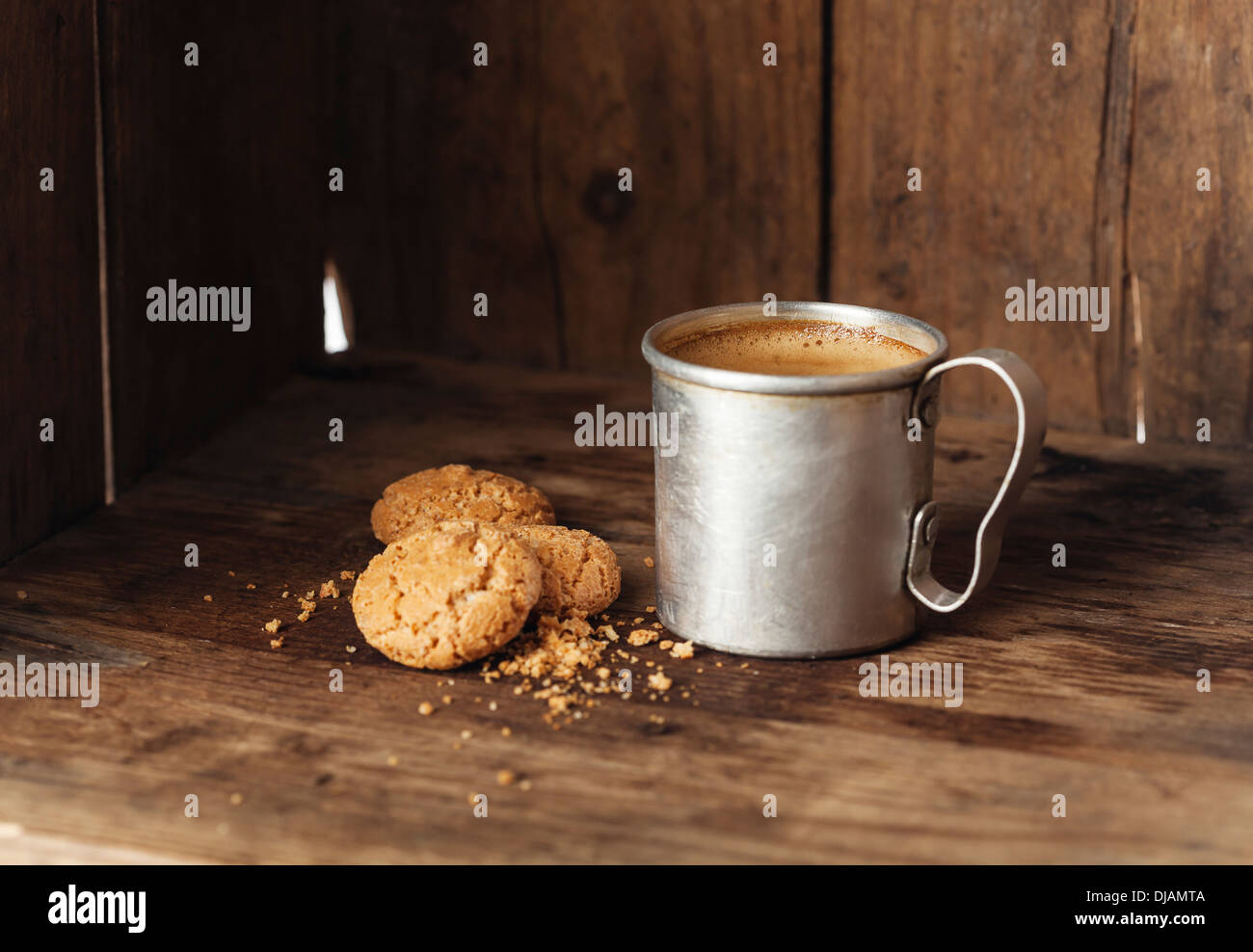 Coffee in aluminum mug with amaretti biscuits Stock Photo
