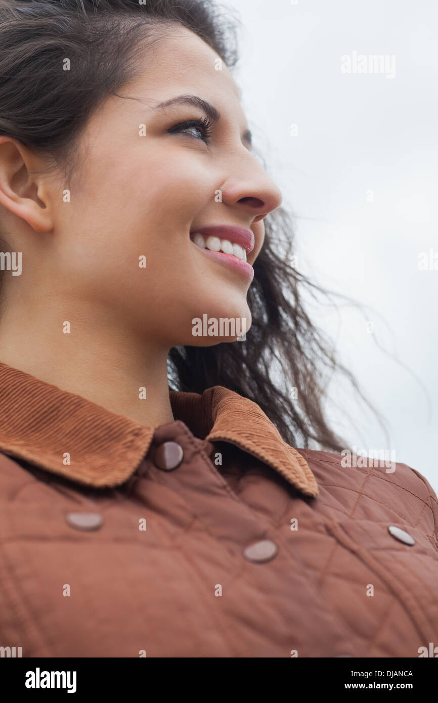 Close up of cute smiling woman in stylish brown jacket Stock Photo