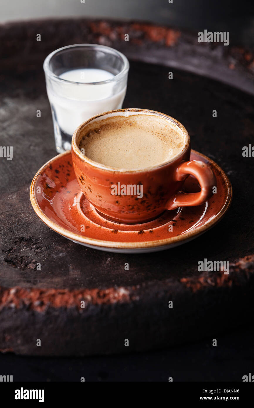 Cup of espresso coffee with milk on dark background Stock Photo