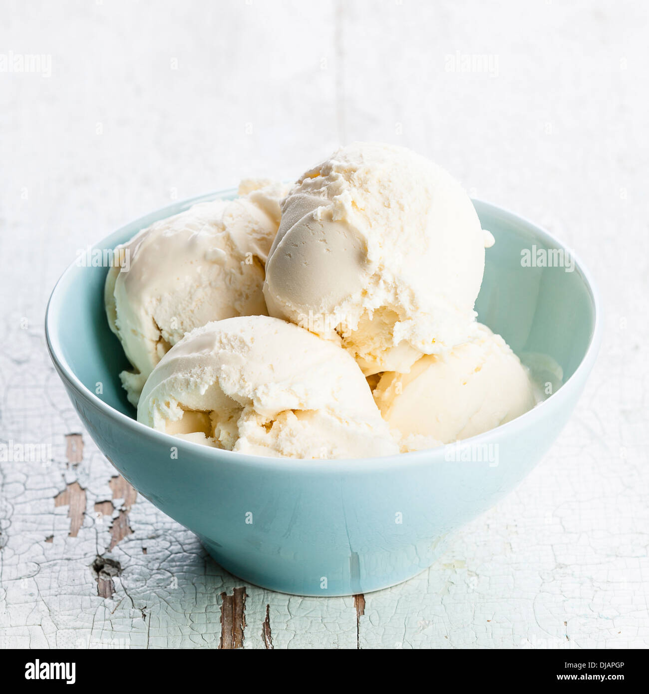 Vanilla ice cream in blue bowl Stock Photo
