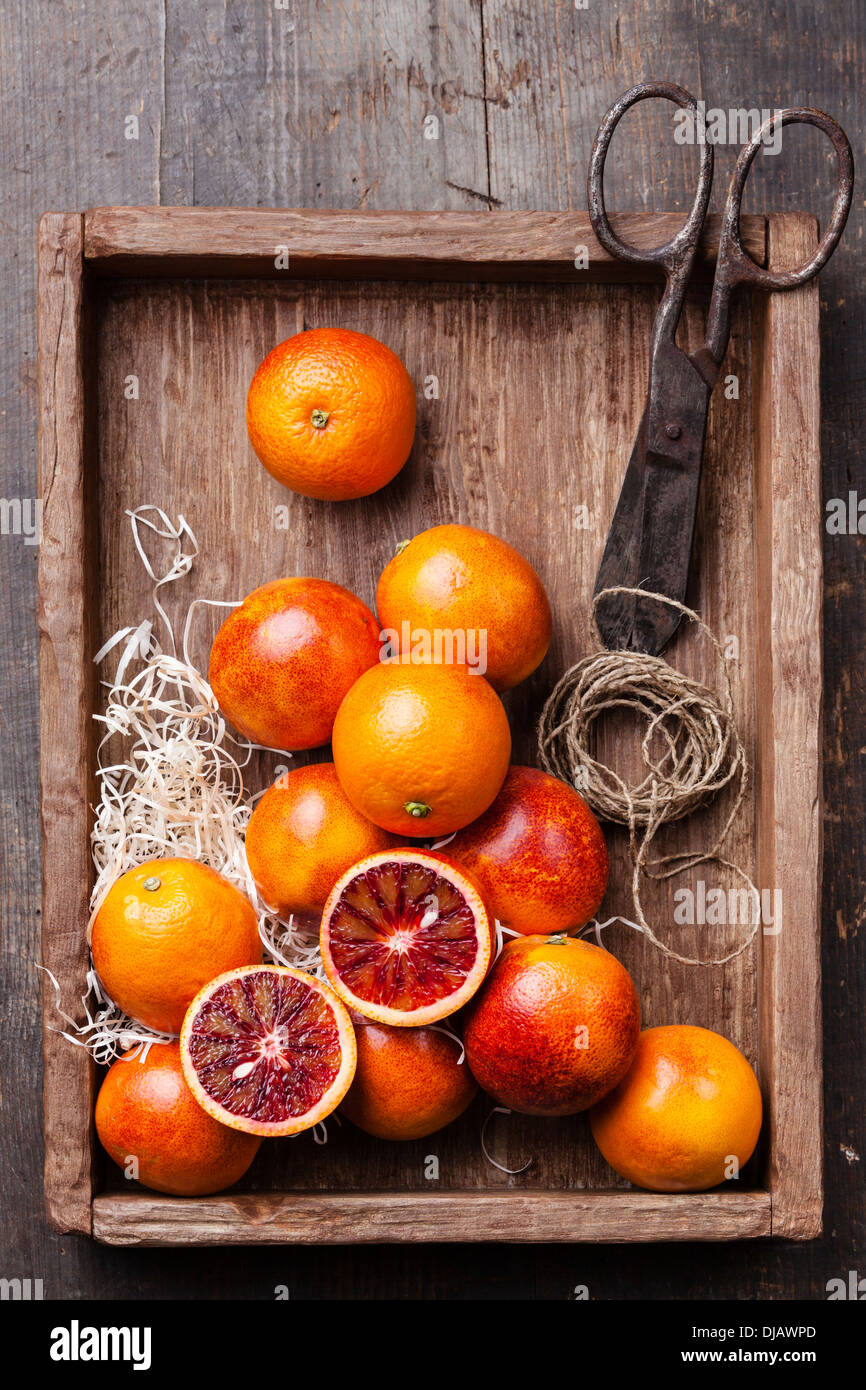 Ripe red oranges on textured wooden background Stock Photo