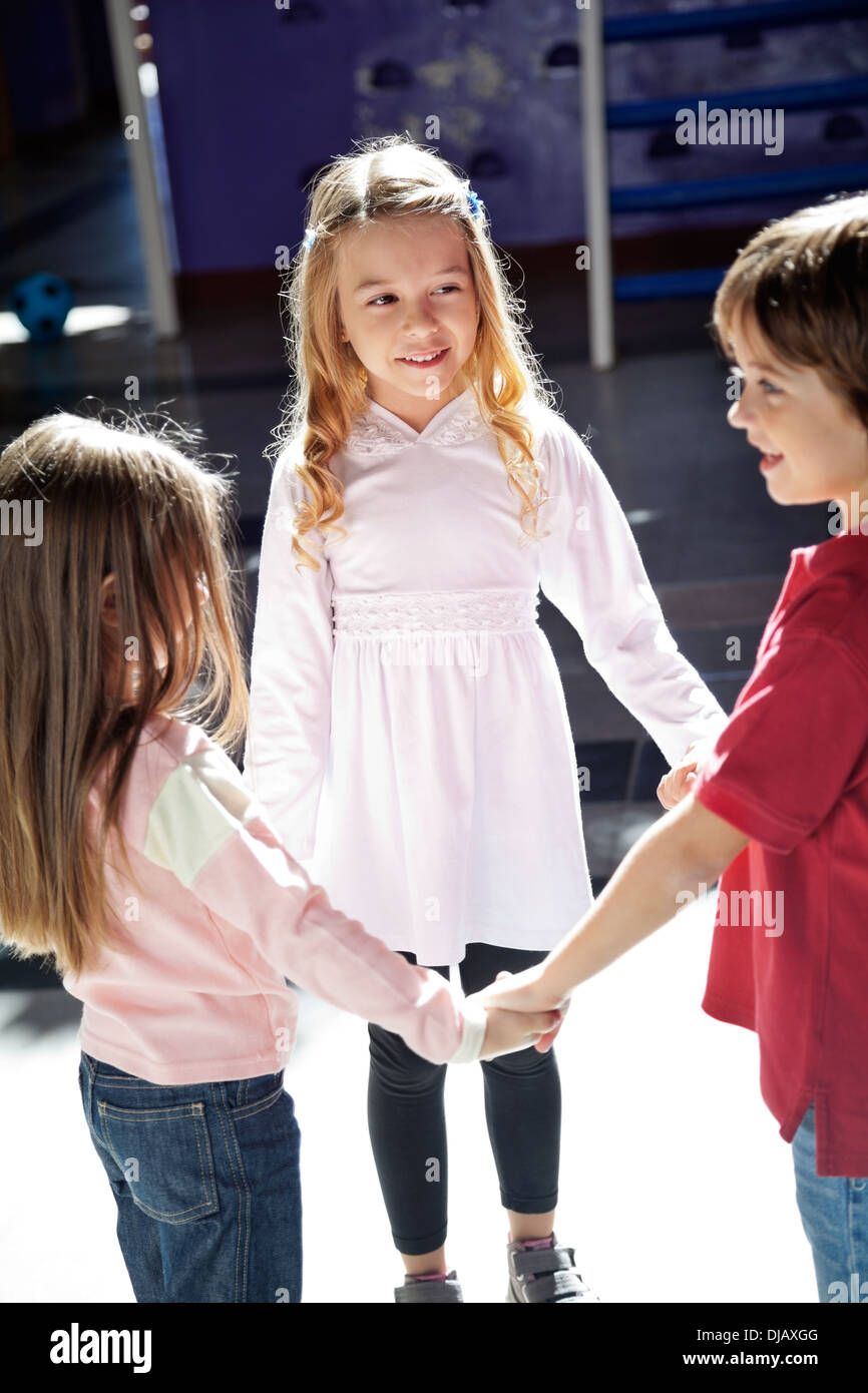 Children Playing While Holding Hands In Preschool Stock Photo