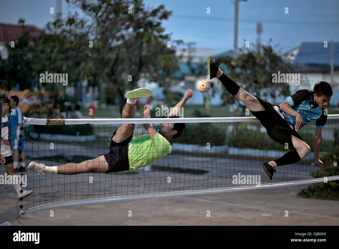 Extreme athleticism during a game of Sepak Takraw. Traditional and popular Thai football game. Thailand S. E. Asia Stock Photo