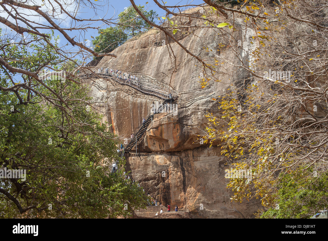Locals and tourists climbing the stairs at Lion's rock at Sigiriya in Sri Lanka Stock Photo
