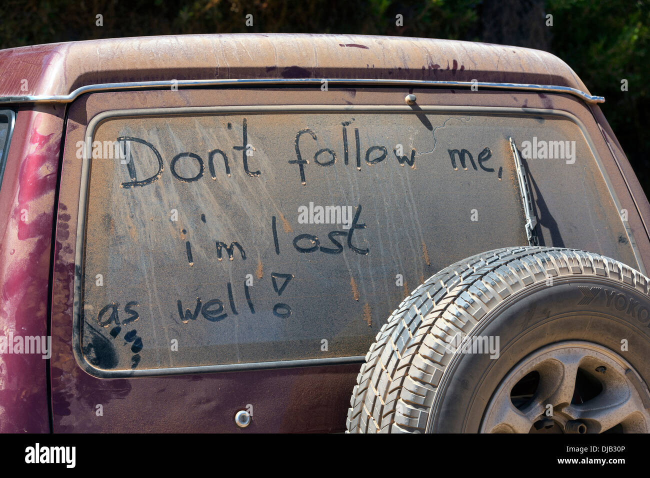 Don't follow me, i'm lost as well, written on dust covered car window Esperance Western Australia Stock Photo