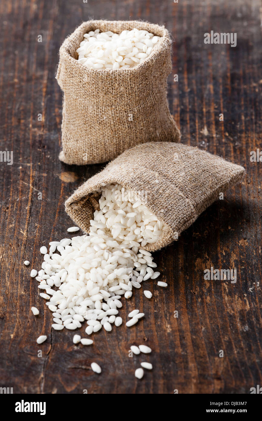 Raw white rice in burlap bag Stock Photo