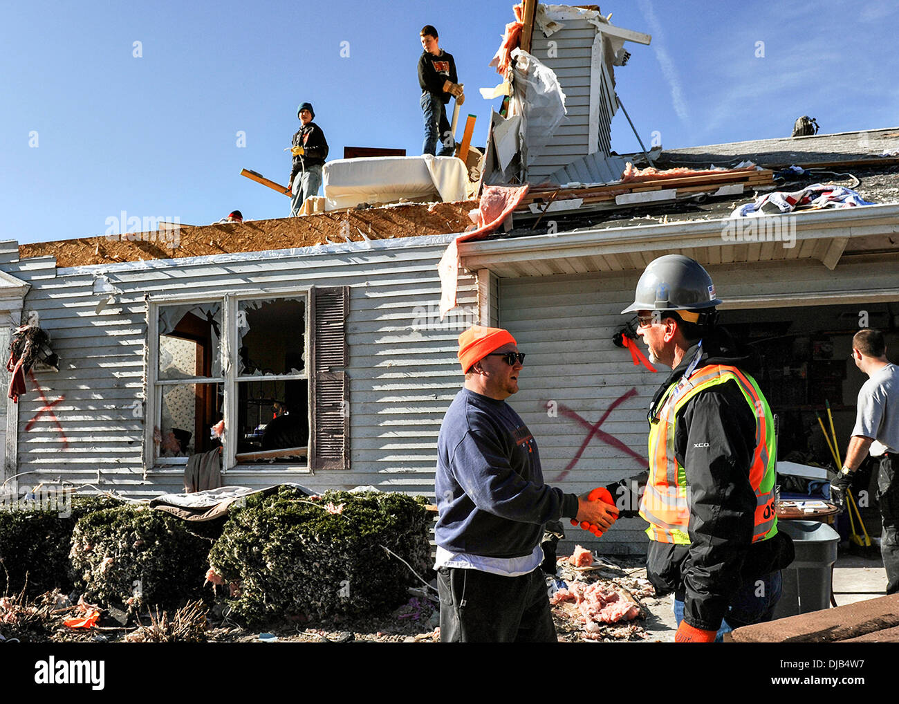 Residents begin demolishing what is left of their home destroyed by an EF-4 tornado November 19, 2013 in Washington, IL. The tornado left a path of destruction that stretched for more than 46 miles and damaged fourteen-hundred homes. Stock Photo