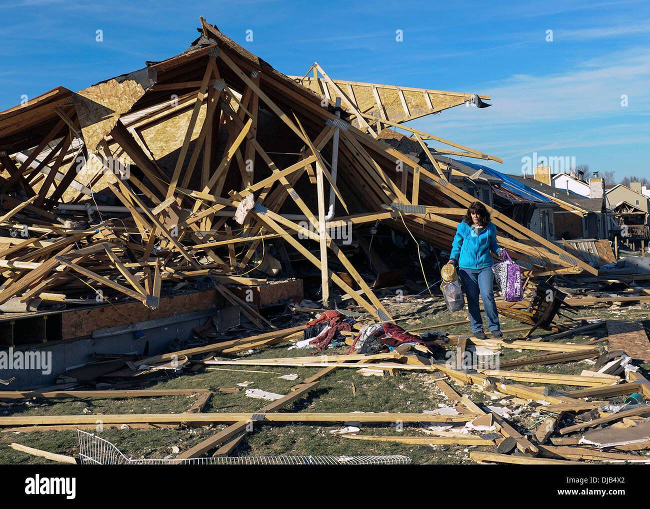 A resident recovers items from her home destroyed by an EF-4 tornado November 19, 2013 in Washington, IL. The tornado left a path of destruction that stretched for more than 46 miles and damaged fourteen-hundred homes. Stock Photo