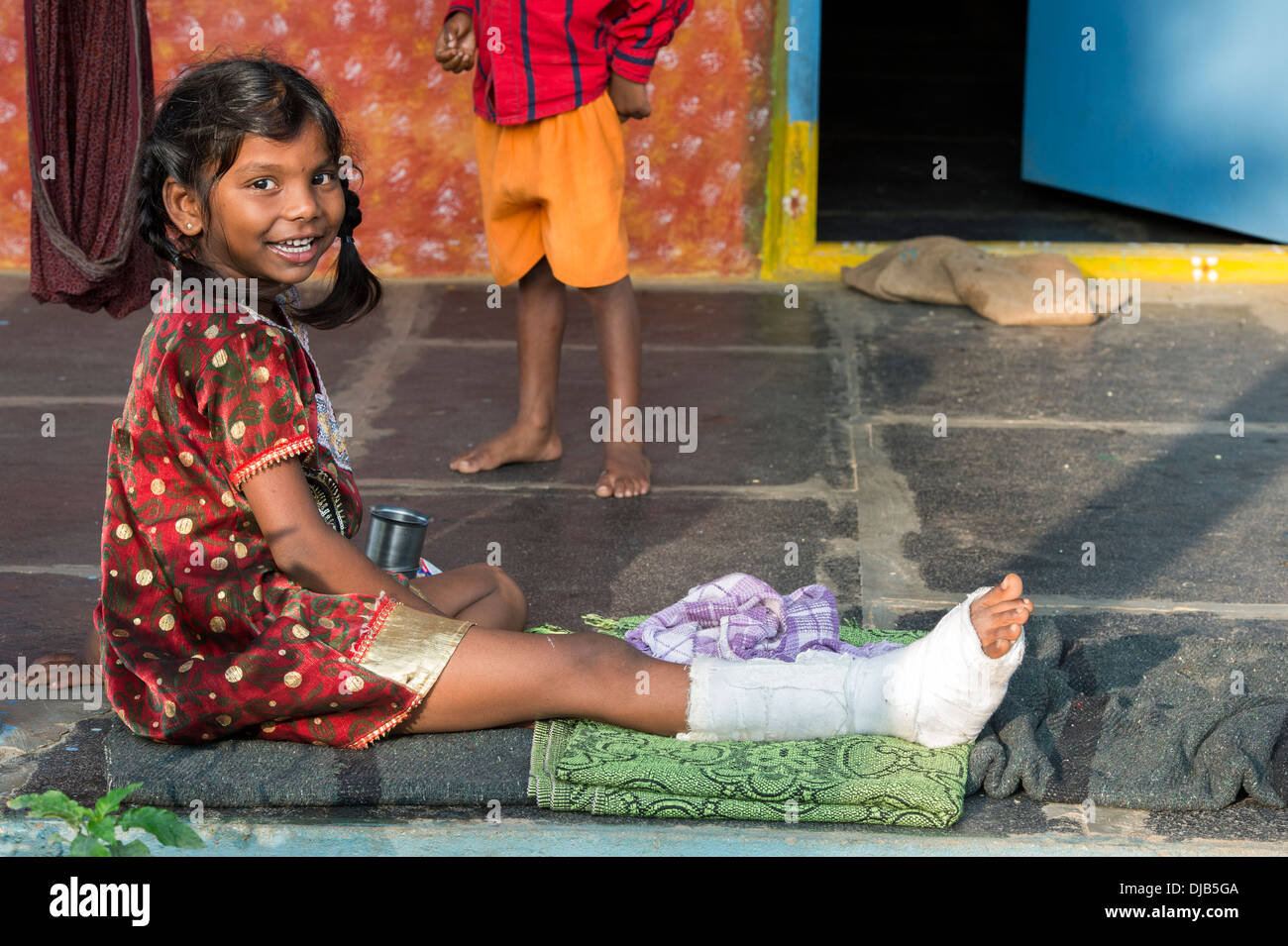 Indian girl with broken leg outside her rural Indian village home. Andhra Pradesh, India Stock Photo