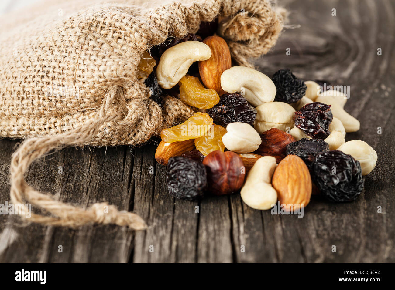 Nuts and dried fruits on wooden background Stock Photo