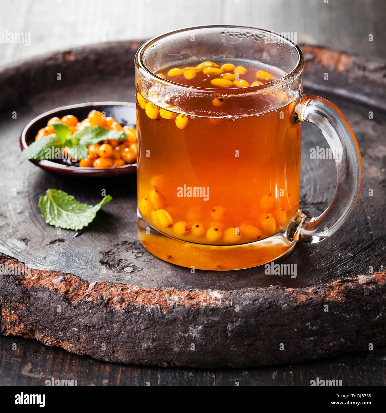 Tea with sea buckthorn on dark background Stock Photo