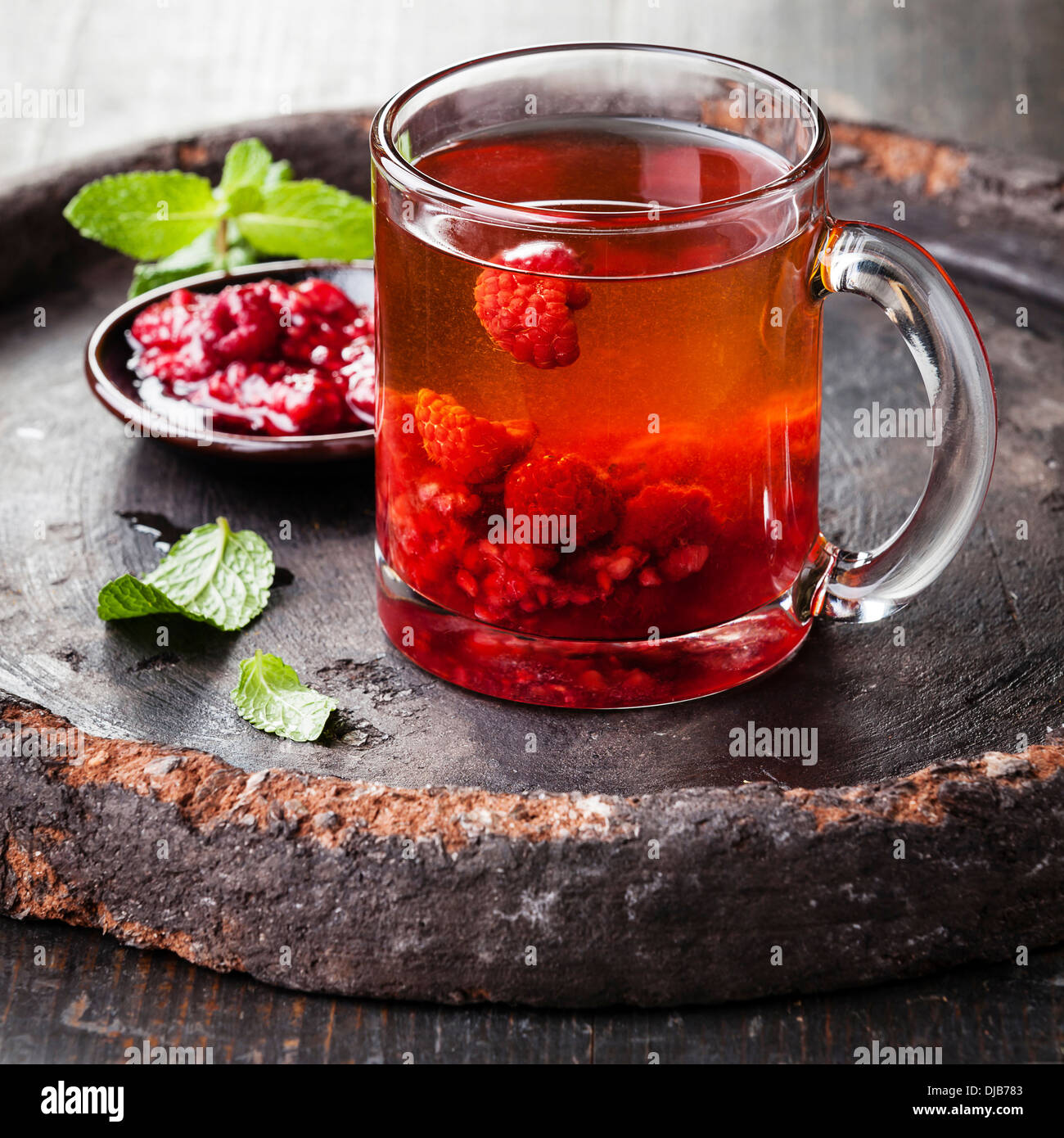 Hot tea with raspberry on dark background Stock Photo